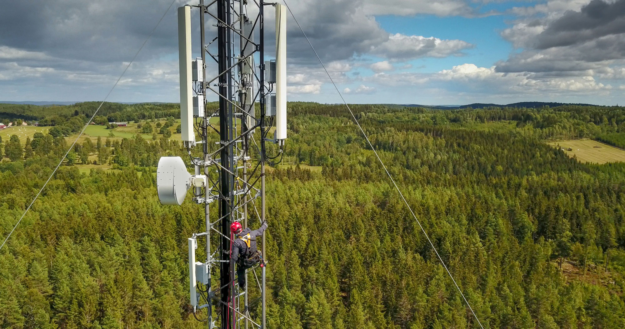 Man climbing a cell phone tower