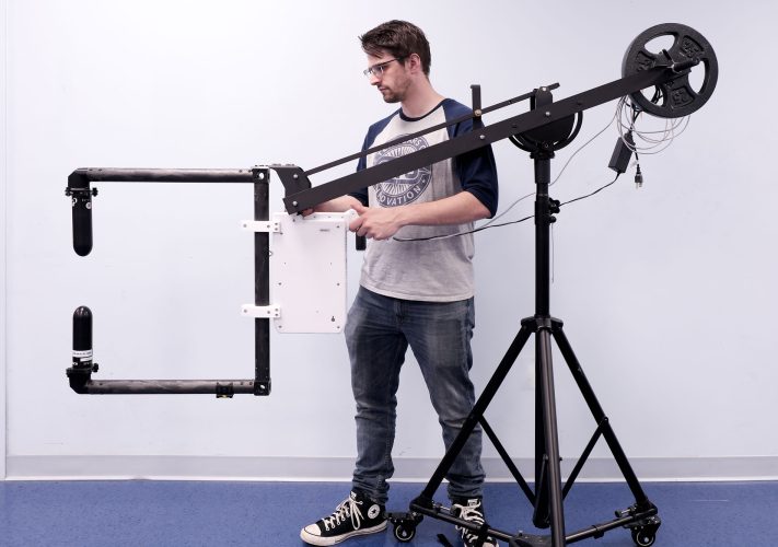 Man setting up a microwave caliper system to measure microwave transmissions