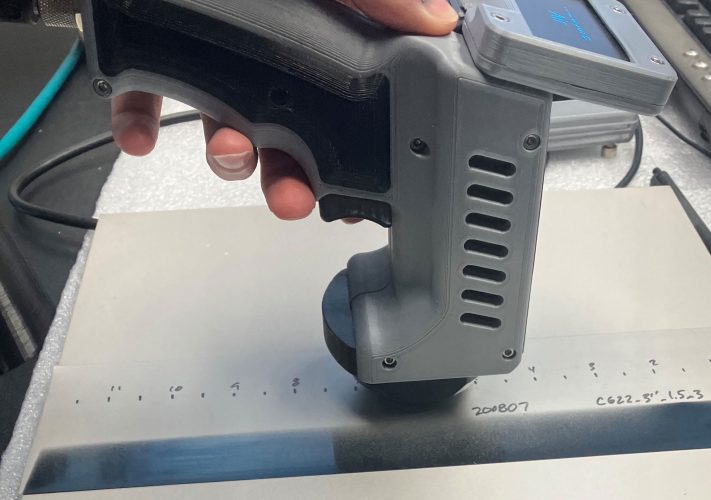 Person using a resonant eddy current sensor, characterizes conductive composites